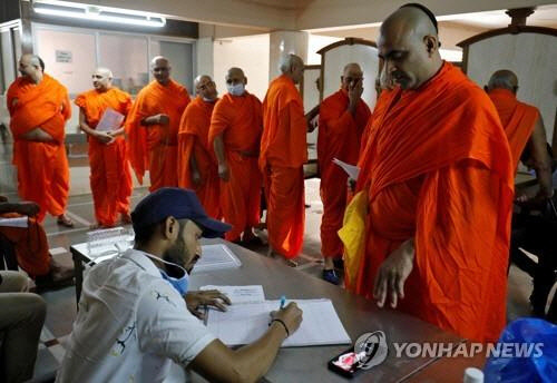 인도 아메다바드에서 코로나19 백신 접종 신청을 하는 힌두교 승려들. [로이터=연합뉴스]